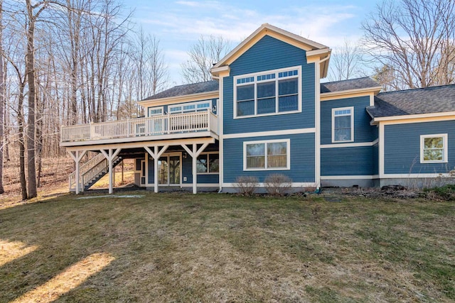 back of property with a deck, a yard, and stairs