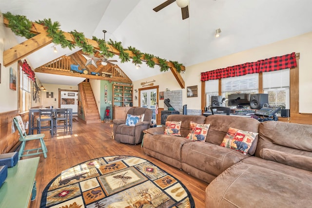 7449 School St, Loudon, NH 03307 - living room with wood finished floors, a ceiling fan, high vaulted ceiling, and stairs