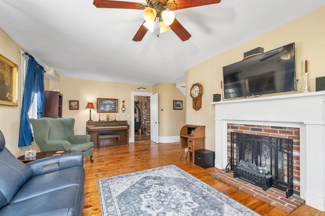 7449 School St, Loudon, NH 03307 - living area featuring baseboards, wood finished floors, ceiling fan, and a brick fireplace