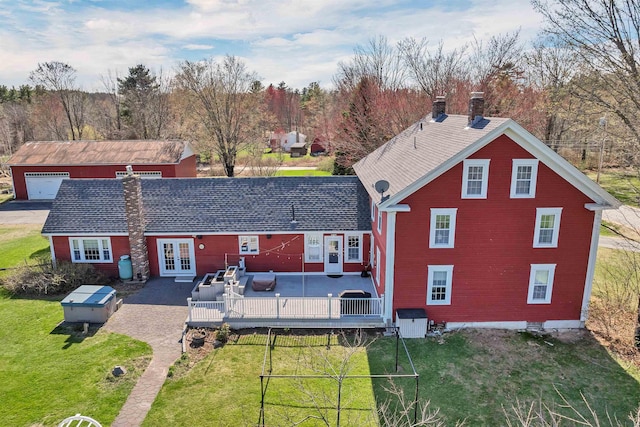 7449 School St, Loudon, NH 03307 - back of property with a chimney, a deck, an outbuilding, a lawn, and french doors