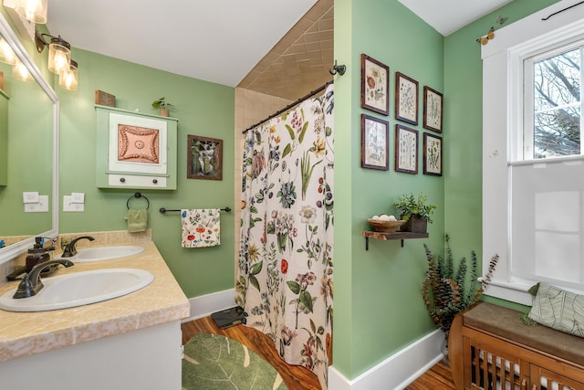 7449 School St, Loudon, NH 03307 - full bathroom featuring baseboards, curtained shower, wood finished floors, and a sink