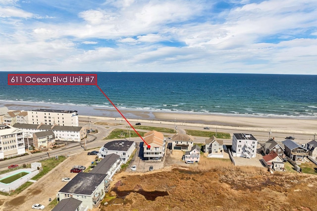aerial view with a water view and a view of the beach