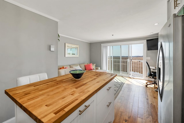 interior space featuring crown molding, recessed lighting, and dark wood-type flooring