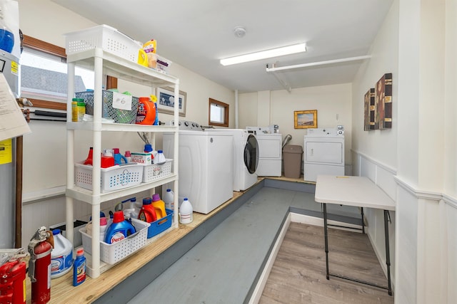 laundry area with wood finished floors, plenty of natural light, separate washer and dryer, and laundry area