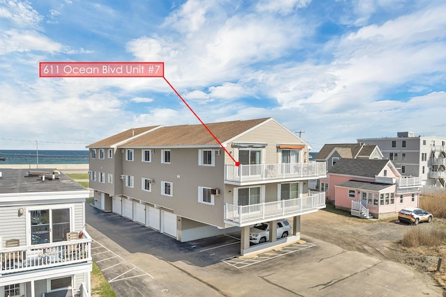 exterior space with community garages and a water view
