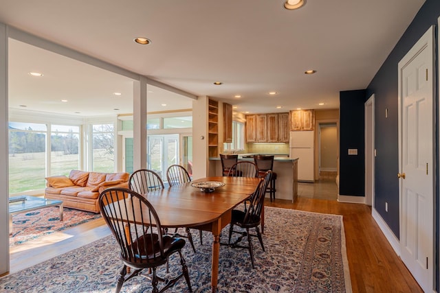 dining room featuring recessed lighting, wood finished floors, and baseboards
