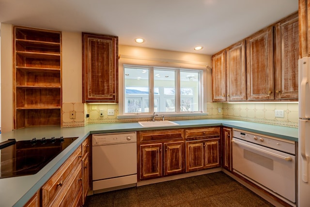 kitchen with white appliances, decorative backsplash, recessed lighting, and a sink