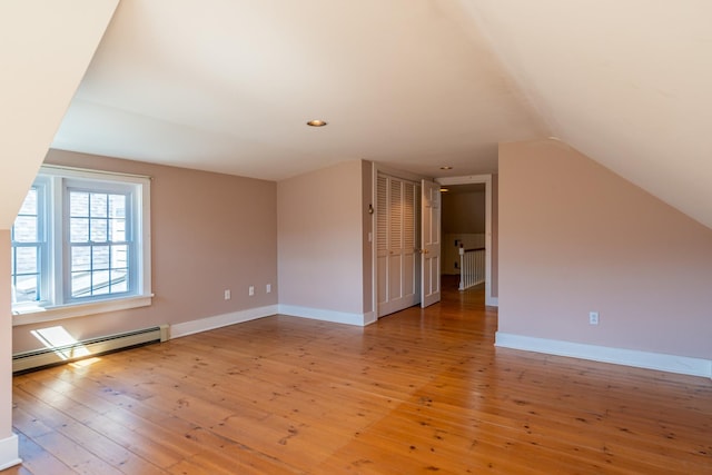 bonus room featuring recessed lighting, a baseboard radiator, vaulted ceiling, wood-type flooring, and baseboards