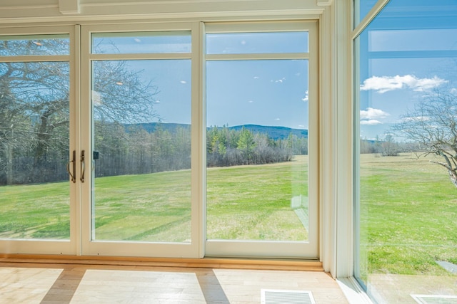 doorway to outside with visible vents and a healthy amount of sunlight
