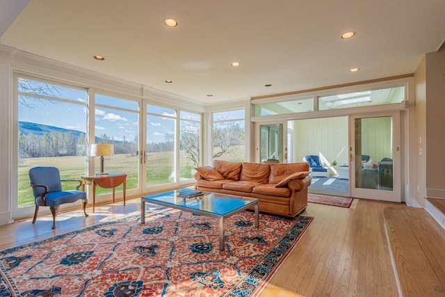 living room featuring light wood-style floors, french doors, recessed lighting, and crown molding