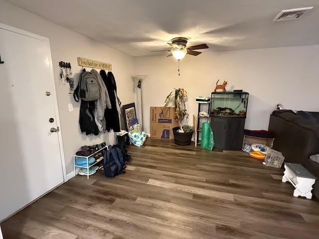 interior space with visible vents, wood finished floors, and ceiling fan