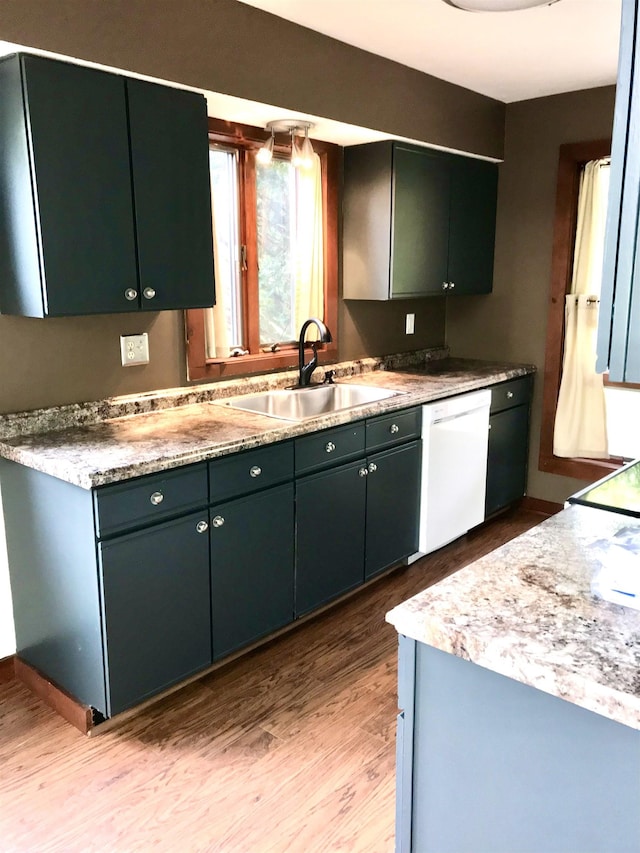 27 Mountainside Ln Unit 5, Francestown, NH 03043 - kitchen featuring dishwasher, a sink, light wood-style floors, and light countertops
