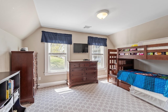 carpeted bedroom with baseboards, visible vents, and vaulted ceiling