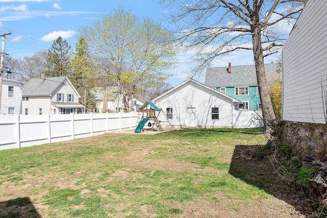 view of yard with a fenced backyard and a playground