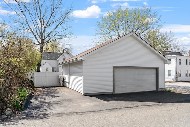 detached garage featuring fence