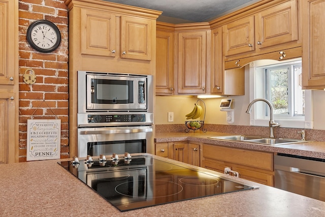 kitchen featuring stainless steel appliances, light countertops, and a sink