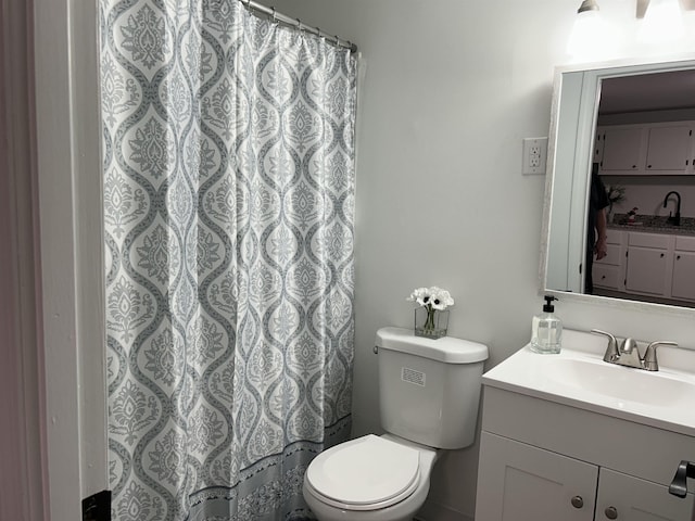 bathroom featuring toilet, a shower with curtain, and vanity