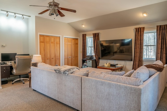 carpeted living area featuring a ceiling fan and vaulted ceiling