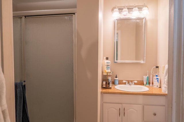 full bathroom with a stall shower and vanity