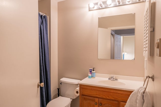 bathroom featuring toilet and vanity