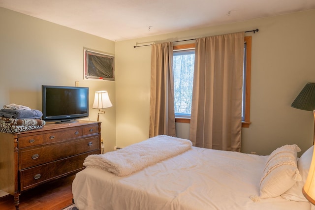bedroom with dark wood finished floors