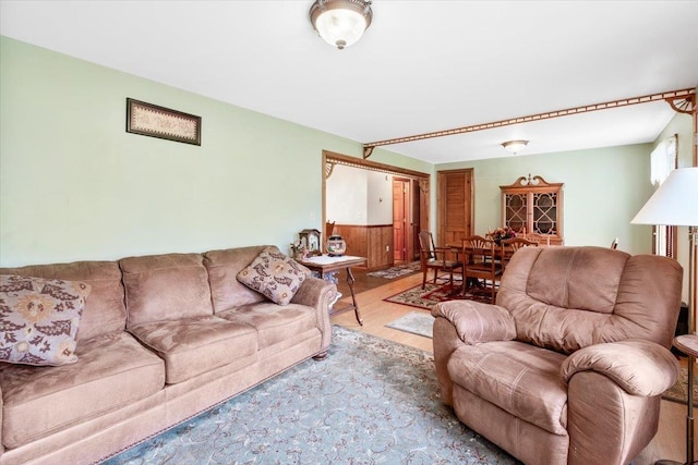 living room with a wainscoted wall and wood finished floors