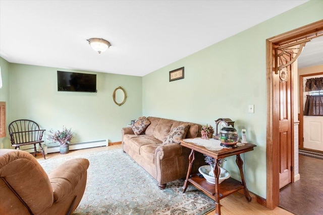 living room with baseboard heating, wood finished floors, and baseboards