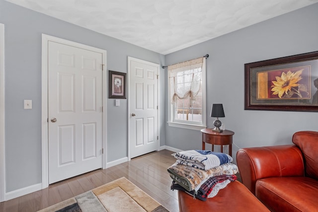 interior space featuring wood finished floors and baseboards