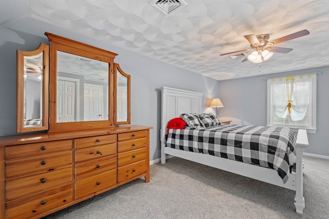 bedroom featuring visible vents, ceiling fan, light colored carpet, and baseboards