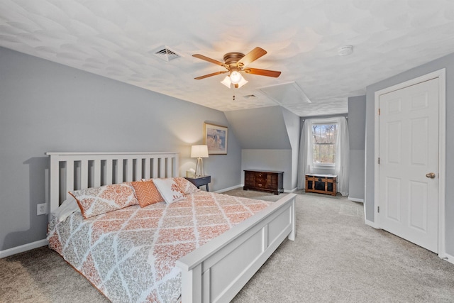 bedroom with lofted ceiling, visible vents, baseboards, and light carpet
