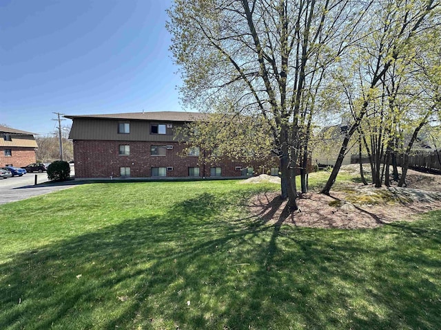 exterior space with a front lawn and brick siding