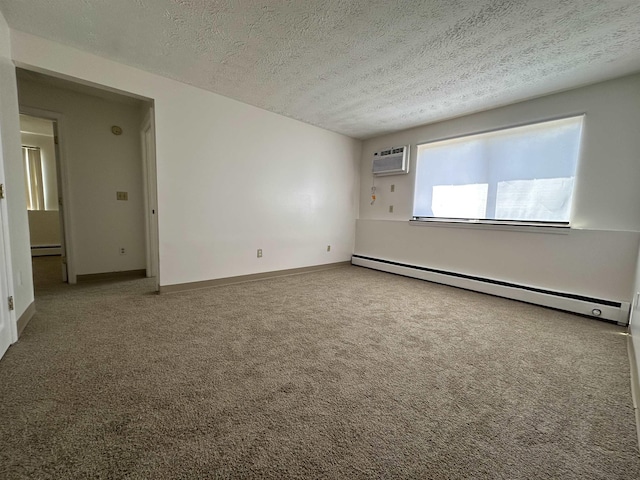 carpeted spare room with a textured ceiling, an AC wall unit, and baseboard heating