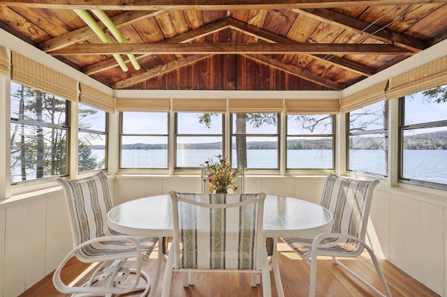 sunroom / solarium with hardwood / wood-style flooring, wood ceiling, a water view, and vaulted ceiling