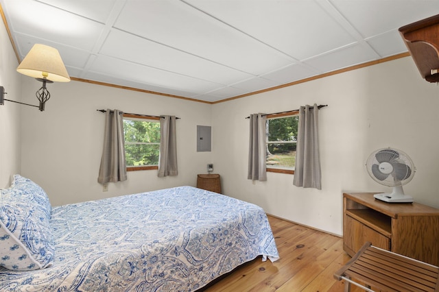 bedroom with wood-type flooring and electric panel