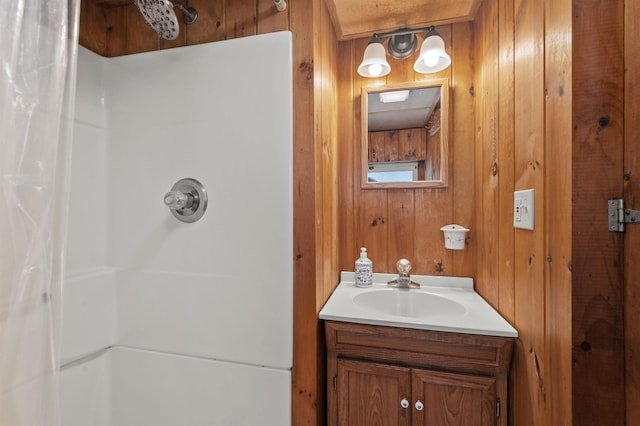 full bathroom with wood walls, a shower with curtain, and vanity