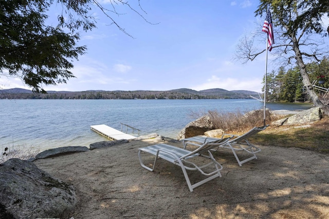 exterior space featuring a mountain view and a boat dock