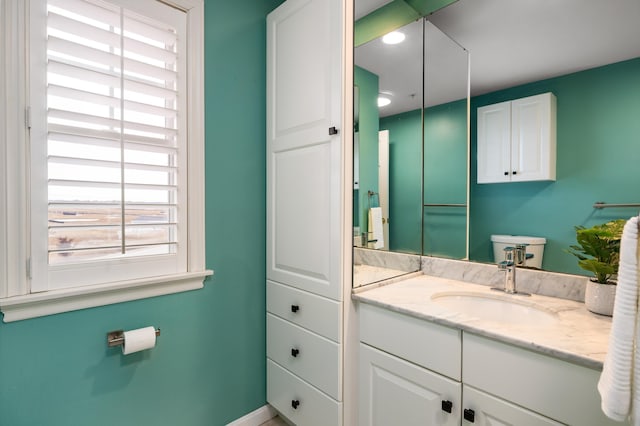 bathroom with baseboards and vanity