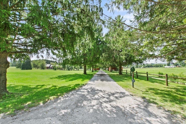 surrounding community with a lawn and fence