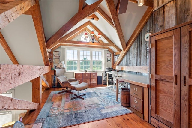 office space featuring wood-type flooring and vaulted ceiling with beams