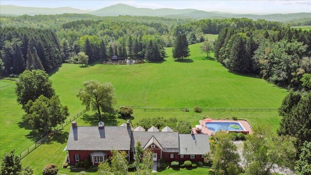 birds eye view of property with a mountain view, a rural view, and a wooded view