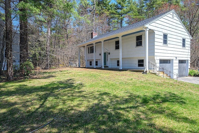 24 Hampton Falls Rd, Exeter, NH 03833 - view of front of house featuring a garage, a chimney, a front yard, and concrete driveway