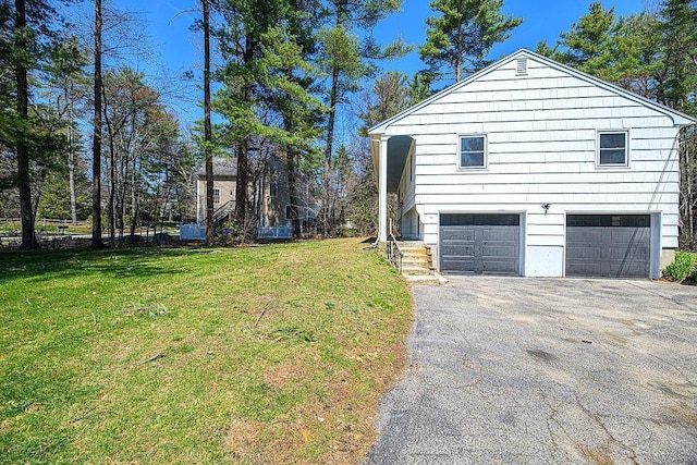 24 Hampton Falls Rd, Exeter, NH 03833 - view of property exterior featuring a garage, asphalt driveway, and a lawn