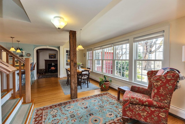 161 Upper Jaffrey Rd, Dublin, NH 03444 - dining room featuring baseboard heating, wood finished floors, a warm lit fireplace, and a baseboard radiator