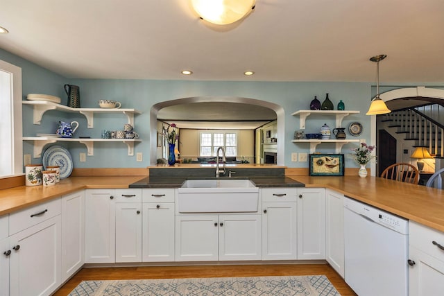 161 Upper Jaffrey Rd, Dublin, NH 03444 - kitchen featuring a sink, open shelves, dishwasher, arched walkways, and light wood-style floors