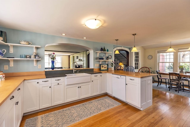 161 Upper Jaffrey Rd, Dublin, NH 03444 - kitchen with arched walkways, open shelves, a sink, and dishwasher