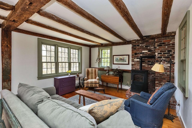 161 Upper Jaffrey Rd, Dublin, NH 03444 - living room with a baseboard radiator, beam ceiling, a wood stove, and wood finished floors