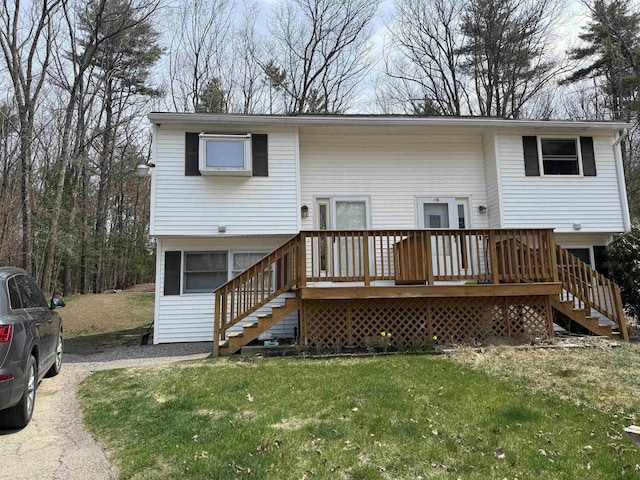 back of property with a yard, stairs, and a wooden deck