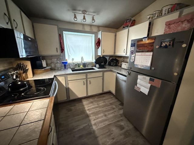 kitchen featuring a sink, white cabinetry, stainless steel appliances, and light countertops