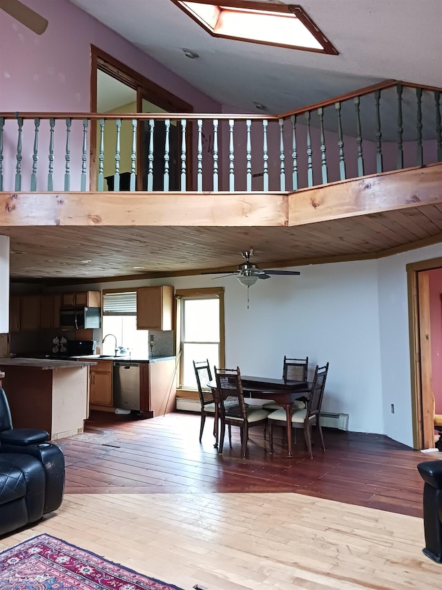 3730 Rte 100, Wardsboro, VT 05355 - dining space with a baseboard radiator, hardwood / wood-style flooring, a high ceiling, and a ceiling fan