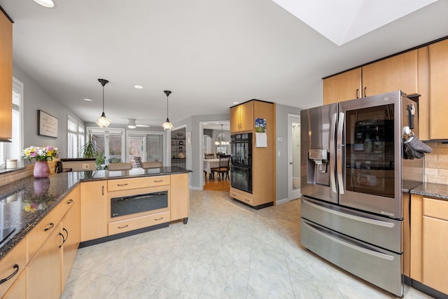 kitchen with dark stone countertops, a warming drawer, stainless steel refrigerator with ice dispenser, pendant lighting, and dobule oven black